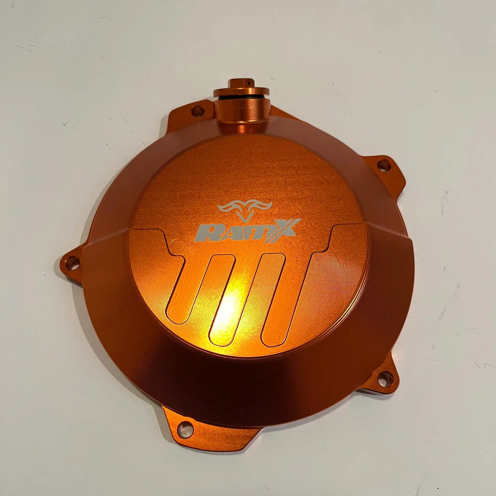 An anodized copper-orange metal motorcycle engine cover featuring a silver 'Brix' logo, photographed on a plain off-white background.
